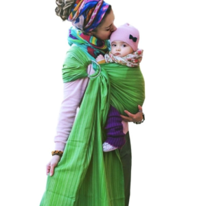 Primer plano de madre besando la cabeza de su bebé porteado en bandolera verde, mostrando la cercanía y el confort del porteo en invierno con gorrito.